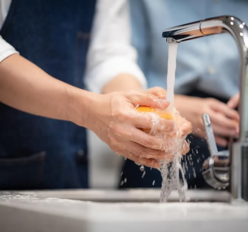 Washing vegetables and fruits for household hygiene.